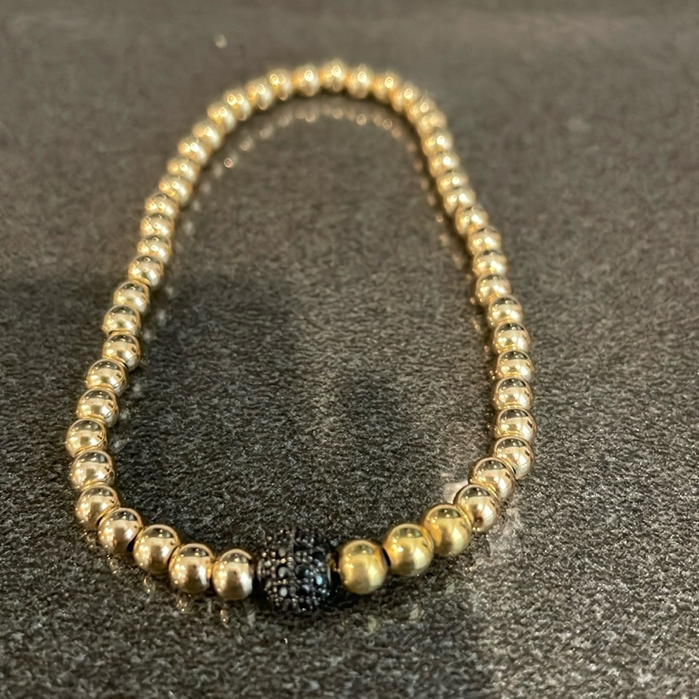 GOLD TONE BALL AND BLACK CRYSTAL BALL STRETCH BRACELET